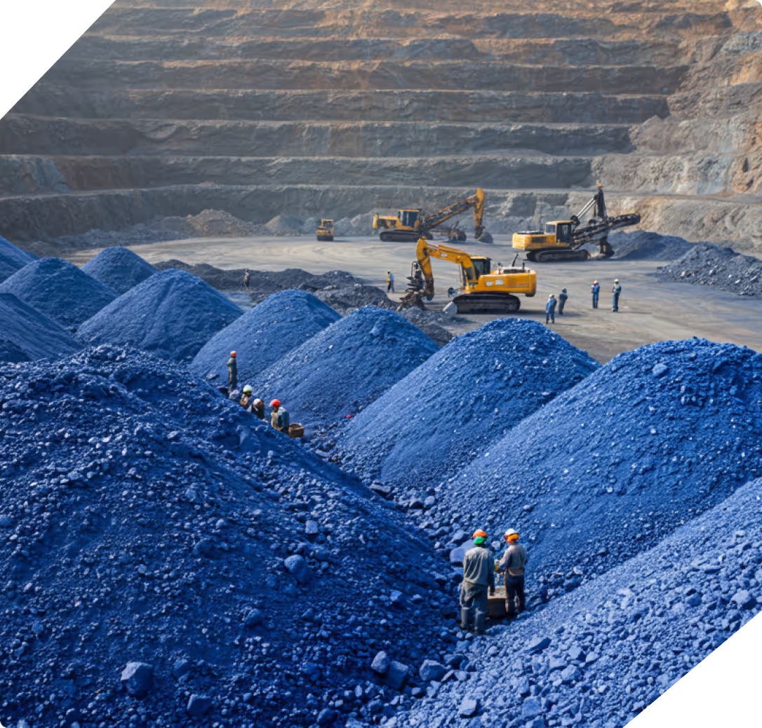 Mine workers standing near piles of processed ore at a Bbabsal Mines site, with heavy machinery visible in the background.